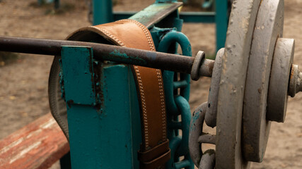 leather belt for weightlifting on vintage old barbell