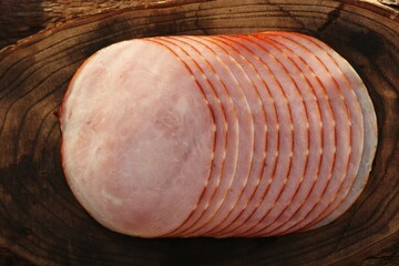 Fresh pink ham on a wooden table   