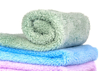 Different multicolor fluffy fabric towel isolated on the white