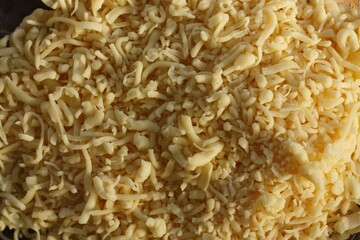 Fresh grated cheese on a plate macro