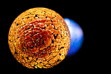 Golden planet with white blue star in deep black space.