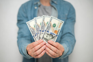 Businessman in blue shirt holds american dollars money on white background, closeup. Money, earnings, crediting and finance.