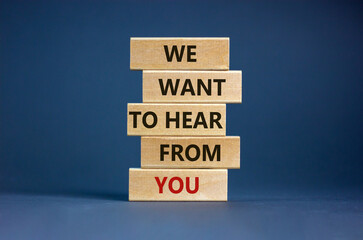 Wooden blocks with words 'we want to hear from you'. Beautiful grey background. Copy space....