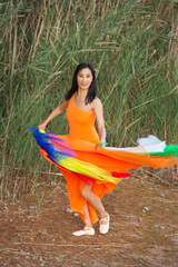 Adult woman dancing with fabric at a reservoir in Connecticut.