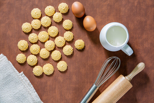 Baking utensils and cooking ingredients for cake bakery include flour, butter, sugar, eggs, and tools on the table, top view with copy space.