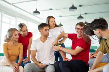group of young caucasian people practice treating a patient by bandages, first aid concept. indoors