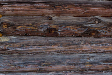 Background image of a brown pine log wall surface. Log cabin, unpainted beautiful debarked wall...