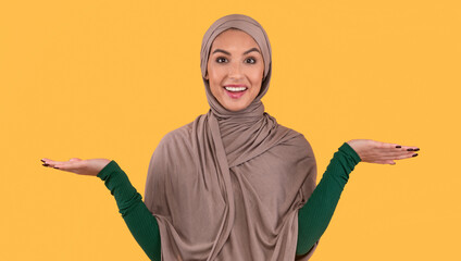 Muslim Lady In Hijab Shrugging Shoulders Standing Over Yellow Background
