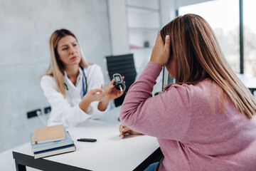 Doctor checking blood sugar level with glucometer of overweight woman. Diabetes test. Healthcare...