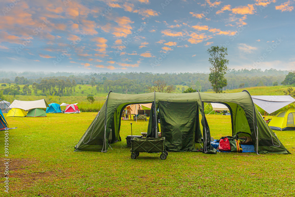 Wall mural Pitch a camping tent in the forest with beautiful sky mountains