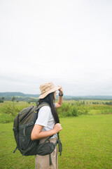 Female tourists carry their backpack freely in the mountain forest Concept of tourism and nature conservation.