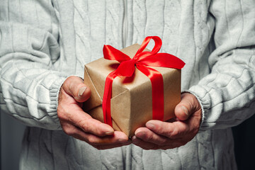 elderly senior holding a christmas present
