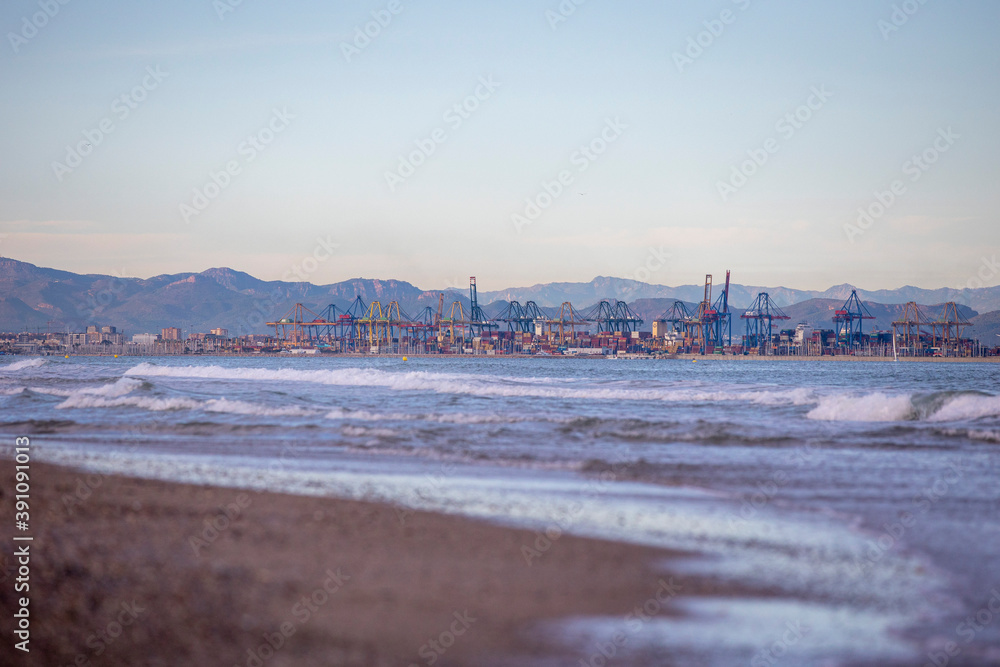 Wall mural cargo port in the distance view from the beach