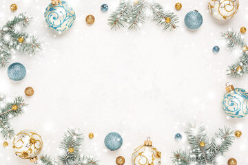 Christmas frame. Snowy white background. Gold, blue New Year decorations, Copy space, winter holiday border.