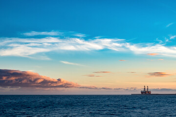 Fototapeta na wymiar Two offshore oil rigs during sunset