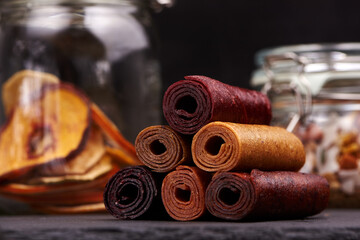 Colorful fruit rolls on dark background
