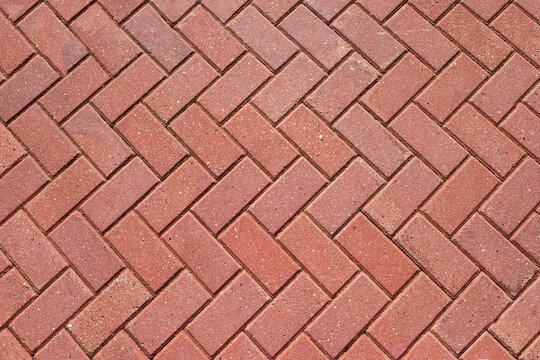 Abstract background from paving red tiles, bricks. Top view of the pavement pattern. Concept for construction, urban environment improvement, finishing works, landscape design