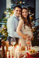 Couple celebrating Christmas, the wife is pregnant