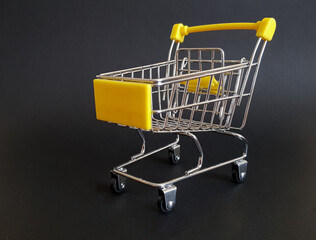 Yellow toy cart on black isolated background