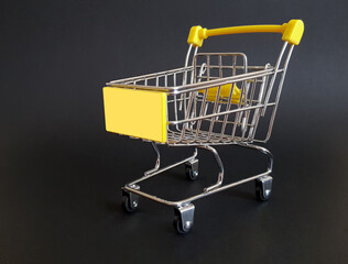 Yellow toy cart on black isolated background