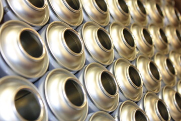 Aerosol cans in factory awaiting filling