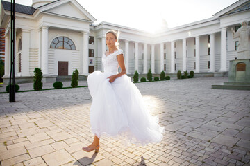 Fototapeta premium Portrait of a young woman in a white ball gown