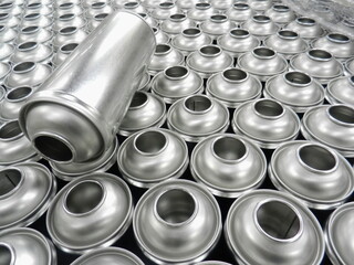 Silver empty aerosol cans in factory