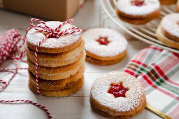 Stack of Linzer Christmas cookies tied to give a present