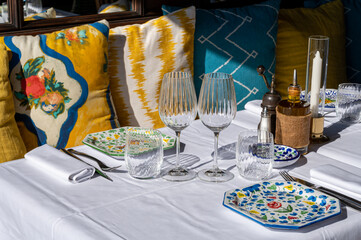 Before lunch time, empty stylish cafes with served tables waiting for guests in Saint-Tropez, Provence, France
