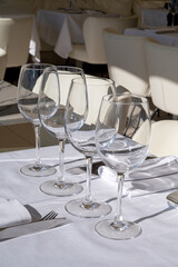 Before lunch time, empty cafes with served tables and tablecloths waiting for guests in Saint-Tropez, Provence, France