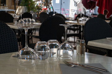 Before lunch time, empty stylish cafes with served tables waiting for guests in Saint-Tropez, Provence, France