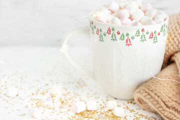 cup with hot chocolate and marshmallows close up on a white background