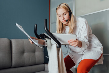 Coronavirus. Quarantine. Lockdown Remote work  home. girl stationary bike works remotely. Home office, social distancing Sports work  home Online learning, work. Coronavirus pandemic world stays home