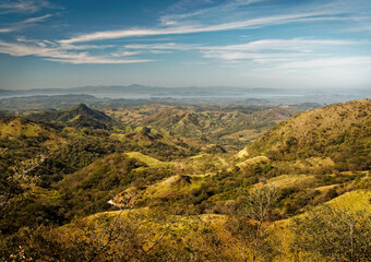 Naklejka premium Landscape from Monte Verde in Costa Rica, mountains and green forests, rainforest and bue sky with the clouds