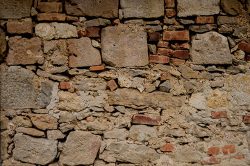 Beige old stone destroying wall.