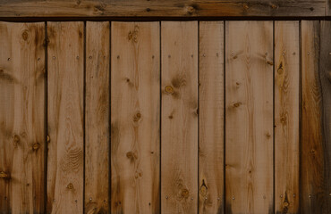 Dark stained reclaimed wood surface with aged boards lined up. Wooden floor planks with grain and texture.