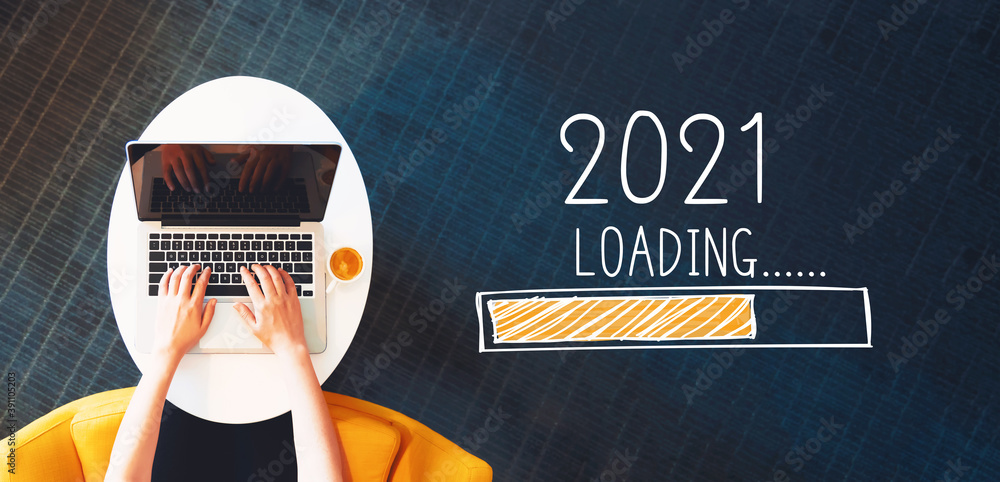 Poster loading new year 2021 with person using a laptop on a white table