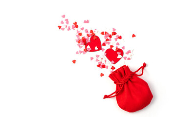 Festive background with hearts flying out of the bag on a white background. The view from the top.