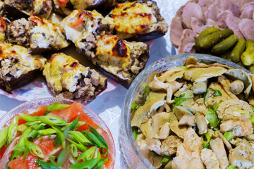 Festive table. Boiled pork tongue with pickles and spices, salted mushrooms seasoned with herbs, stuffed eggplant.