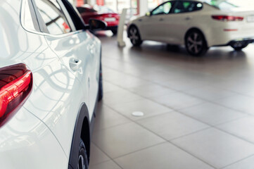 New white cars at dealer showroom with blurred background