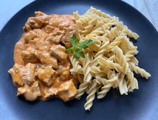 Classic chicken meat goulash with fusilli pasta in sour creme sauce.