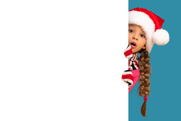 Little girl in a Christmas hat on a white background.