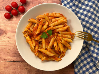Penne pasta with tomato sauce. Vegetarian food concept.