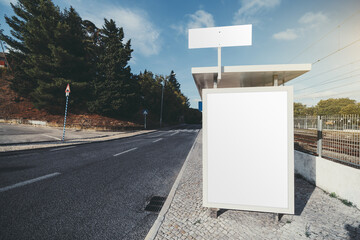 A bus stop near the road and a forest with a mockup of a blank advert poster on it; a template of...