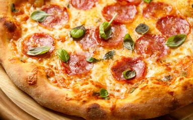 Christmas Salami, Pepperoni Pizza with decoration, gifts, green tree branch on wooden rustic table.