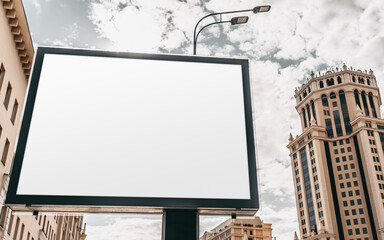 Mock-up of a big empty advert billboard in city settings above the street; an empty information banner template outdoors; an outdoor blank poster placeholder mockup with a skyscraper behind it