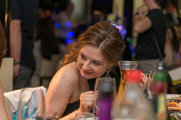 Portrait of handsome young happy woman in restaurant, London, UK