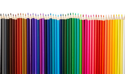 Many colorful pencils in a row isolated on white background.