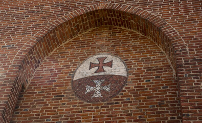 emblem of Elblag on a brick wall