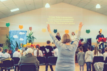 People praying in a church. soft focus of christian people group raise hands up worship God Jesus...